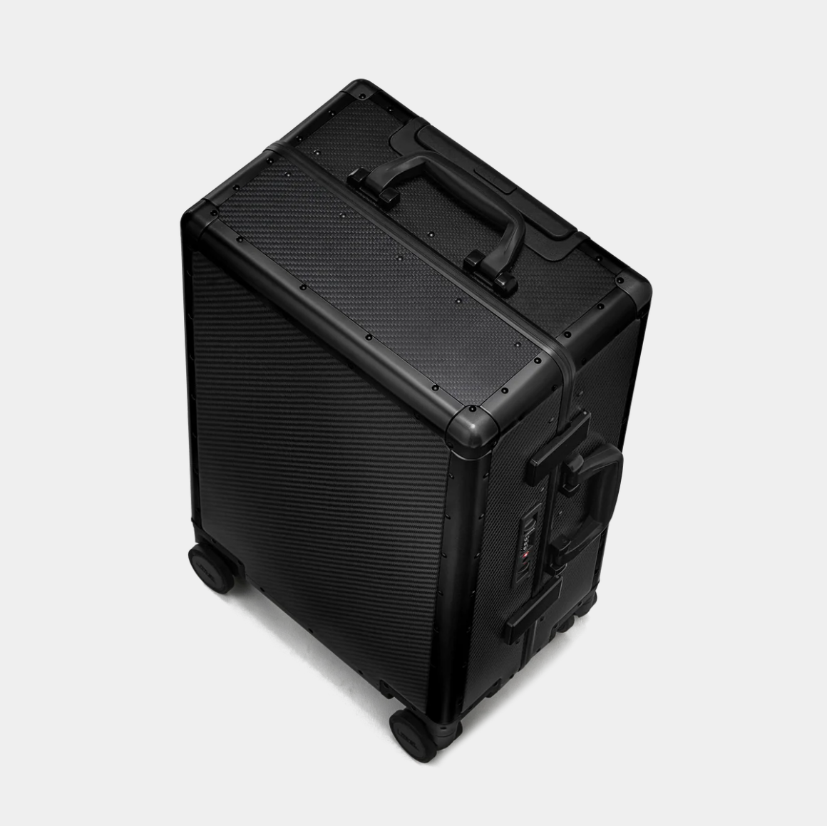 Karbon™ Lightweight Carbon Fiber 20-inch and 24-inch hardside spinner suitcases featuring a reinforced aluminum frame and dual TSA locks on a studio background.