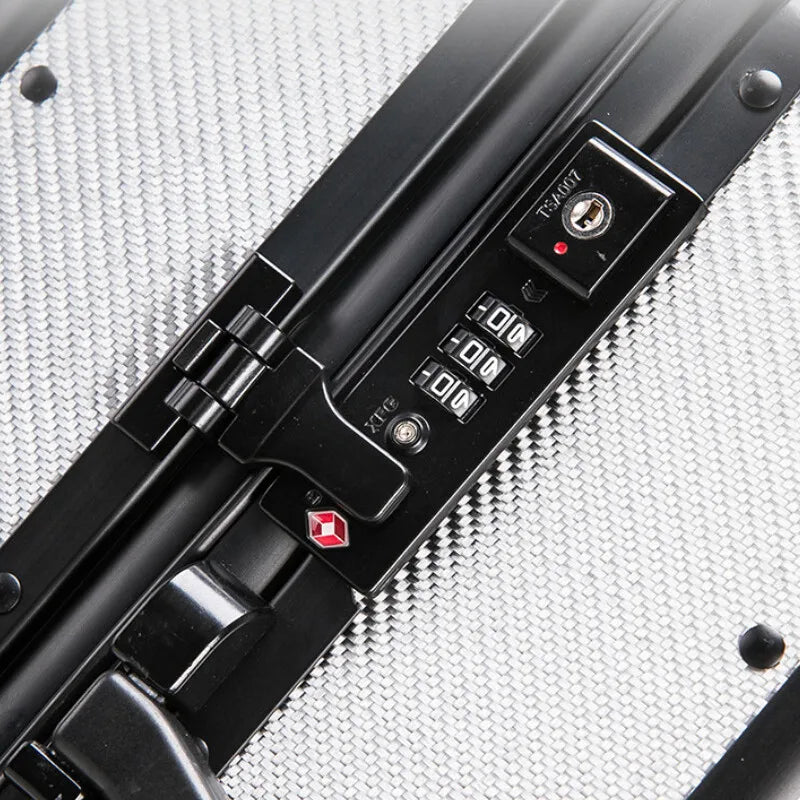 Karbon™ Lightweight Silver Carbon Fiber 20-inch and 24-inch hardside spinner suitcases featuring a reinforced aluminum frame and dual TSA locks on a studio background.