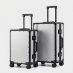 Karbon™ Lightweight Silver Carbon Fiber 20-inch and 24-inch hardside spinner suitcases featuring a reinforced aluminum frame and dual TSA locks on a studio background.