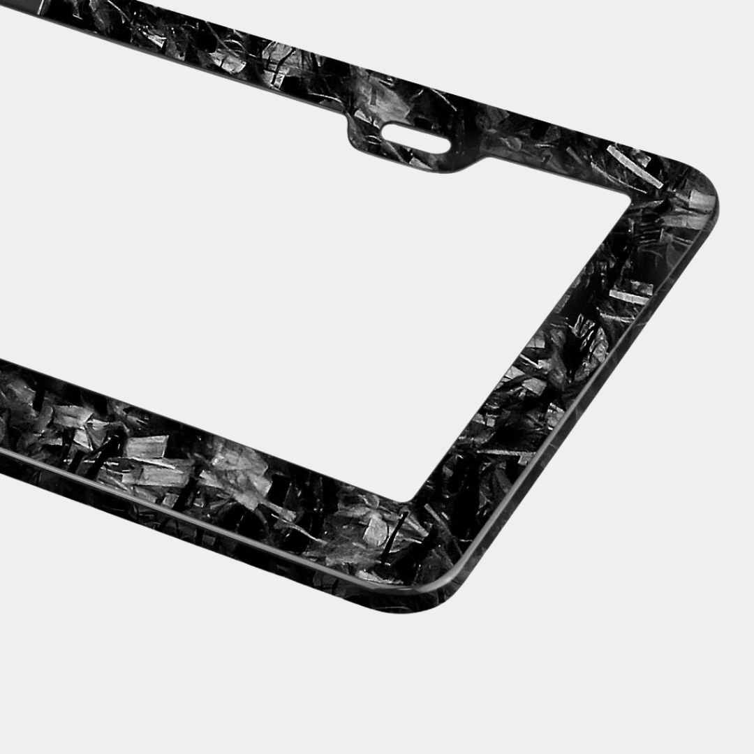 Karbon Technik forged carbon car licence plate frame detail, showing the marbled black and grey carbon finish.