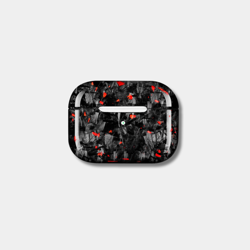 Apple AirPods case made from genuine forged carbon fiber with vibrant red specks by Karbon Technik, displaying a high-gloss marbled composite finish.