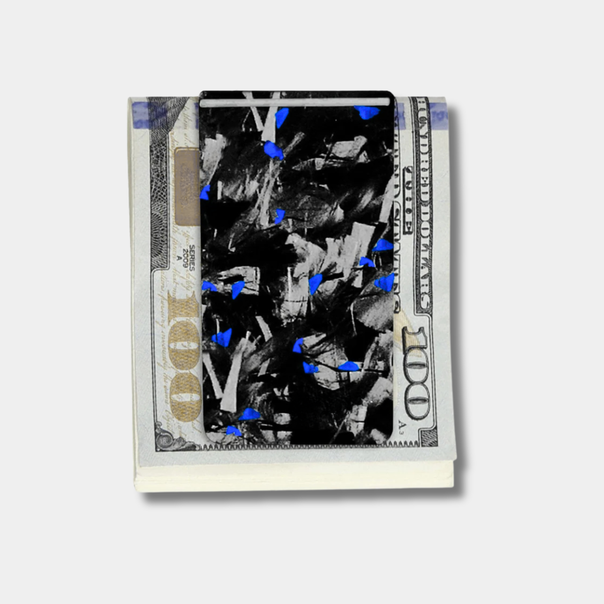 Forged Karbon™ money clip in black composite with blue accents holding bills by Karbon Technik.