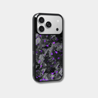 Genuine forged carbon fiber iPhone case by Karbon Technik, featuring vibrant purple flakes, protective raised edges, and MagSafe compatibility.