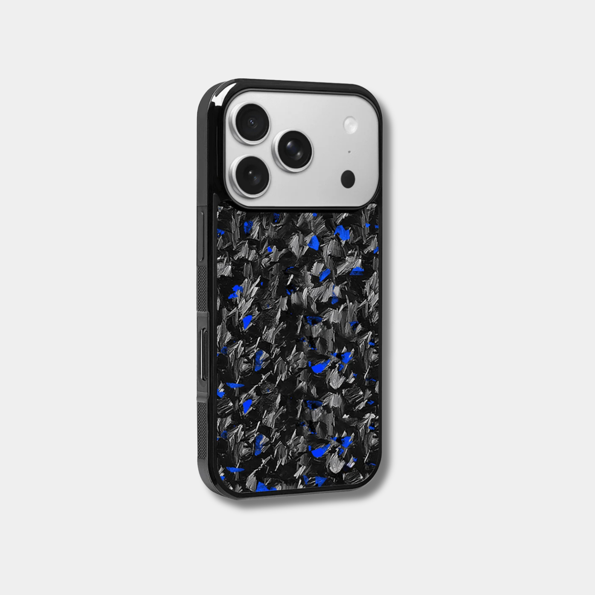 Genuine raw carbon fiber iPhone case by Karbon Technik, featuring vibrant blue flakes, protective raised edges, and MagSafe compatibility. 