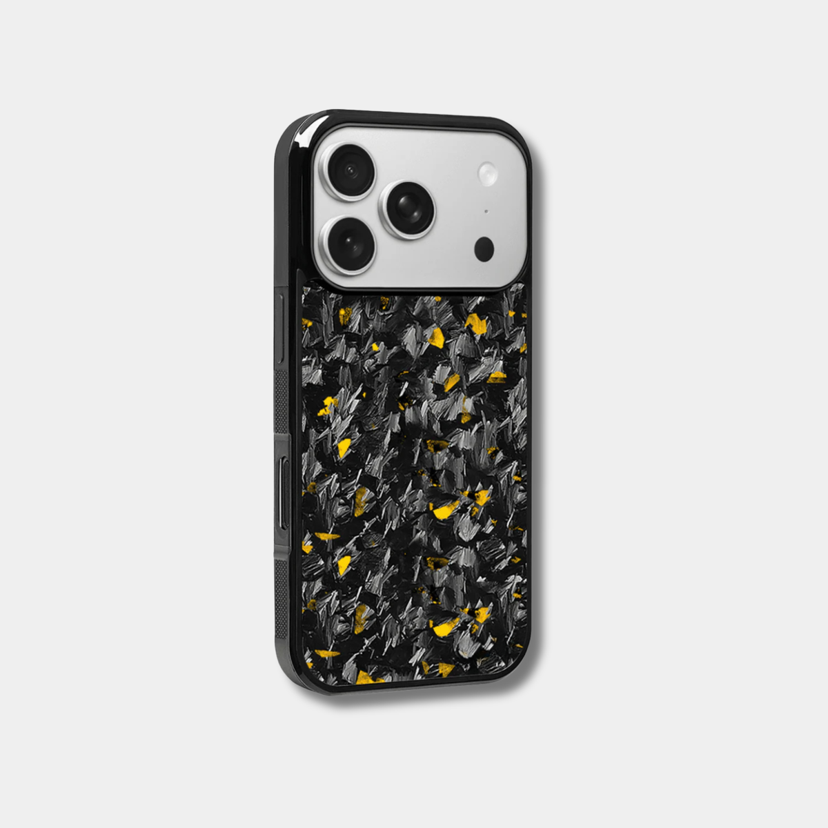 Genuine raw carbon fiber iPhone case by Karbon Technik, featuring vibrant gold flakes, protective raised edges, and MagSafe compatibility.  