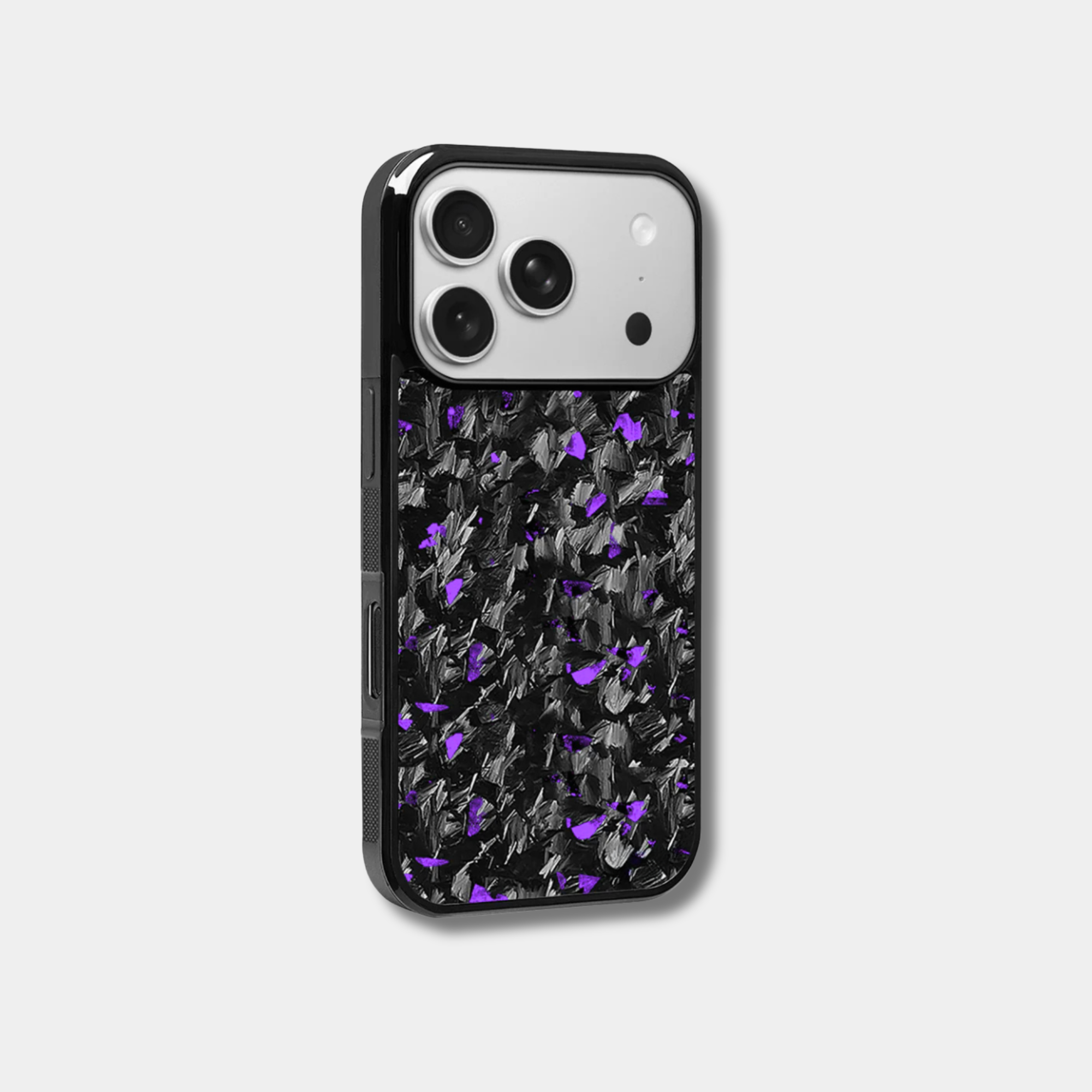 Genuine raw carbon fiber iPhone case by Karbon Technik, featuring vibrant purple flakes, protective raised edges, and MagSafe compatibility.