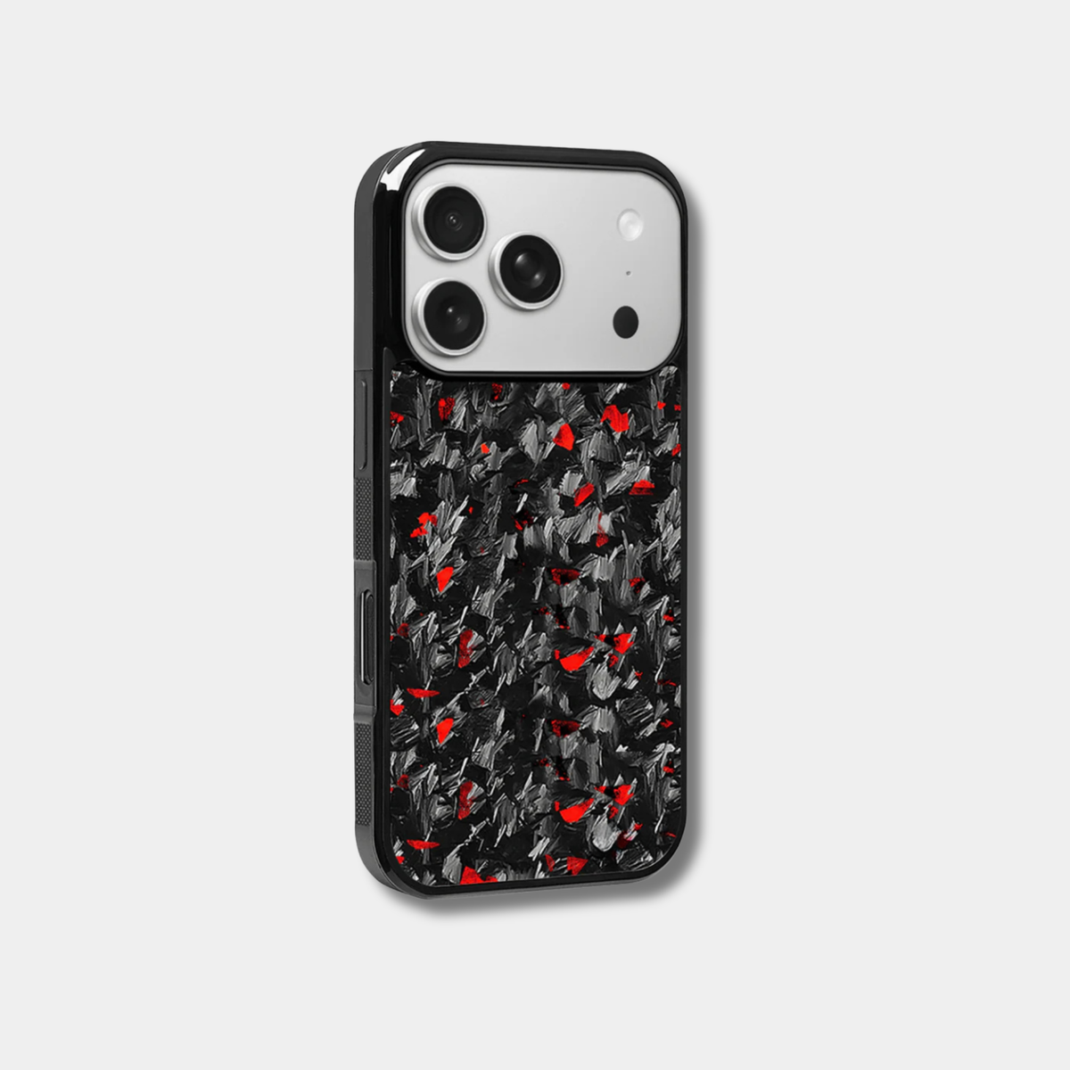 Genuine raw carbon fiber iPhone case by Karbon Technik, featuring vibrant red flakes, protective raised edges, and MagSafe compatibility.  